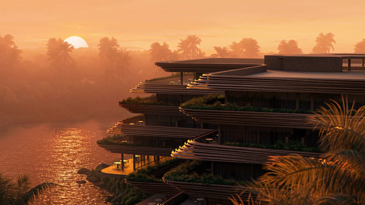 Waterfront residential architecture in Miami at sunset, warm light reflecting off the water and glass facade