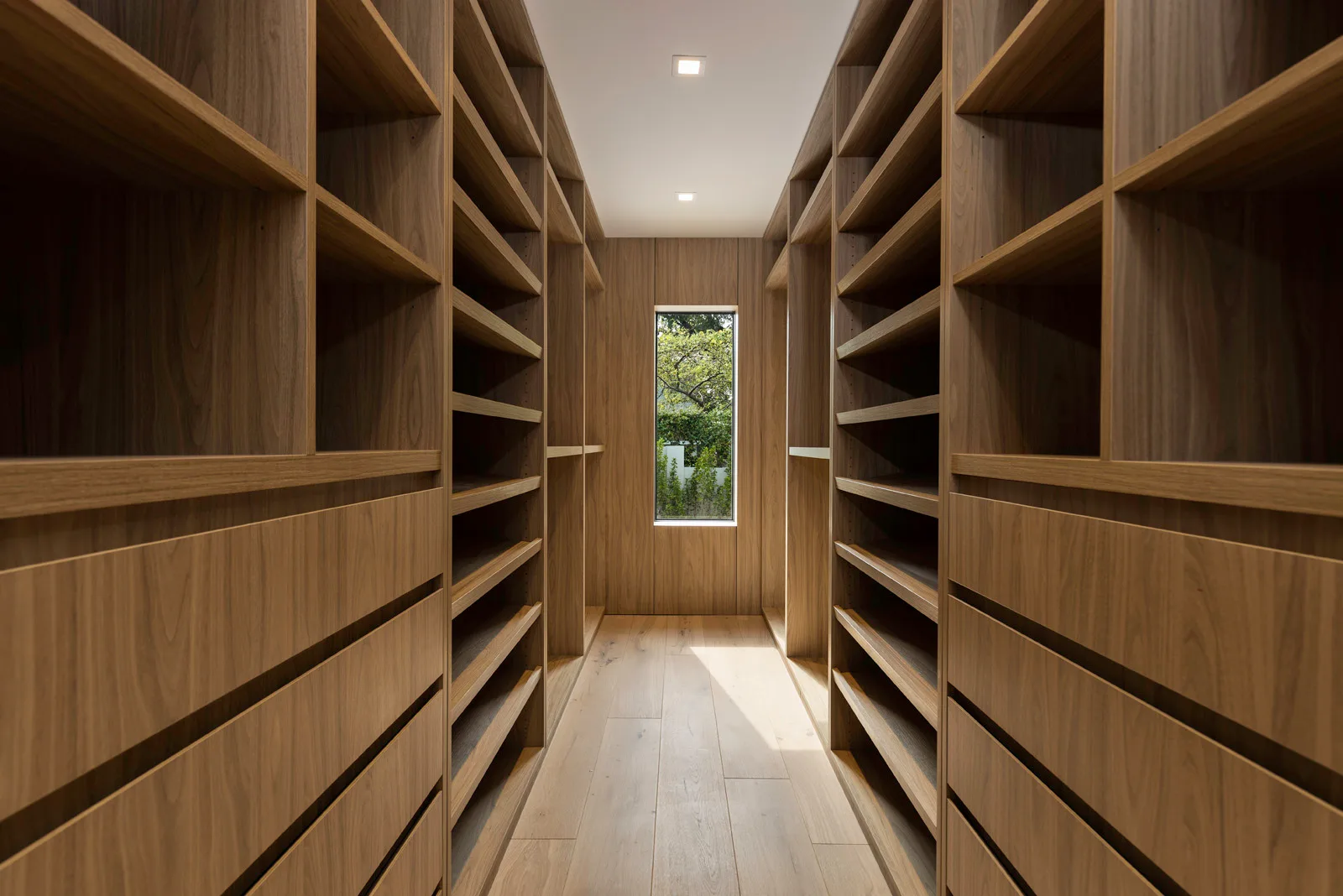 Remodelled spa bathroom with an oak vanity and natural stone in the Samana residence by LUXOM