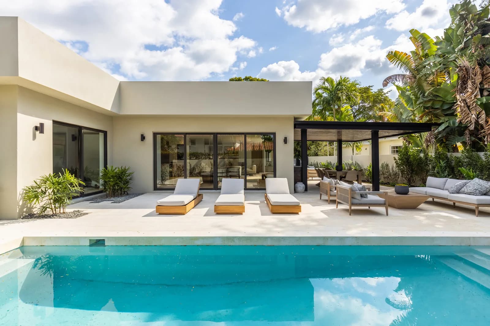 The finished pool and rear terrace at the Samana Residence in Coconut Grove, Miami, the same backyard shown in Luxom's excavation to finish build timelapse