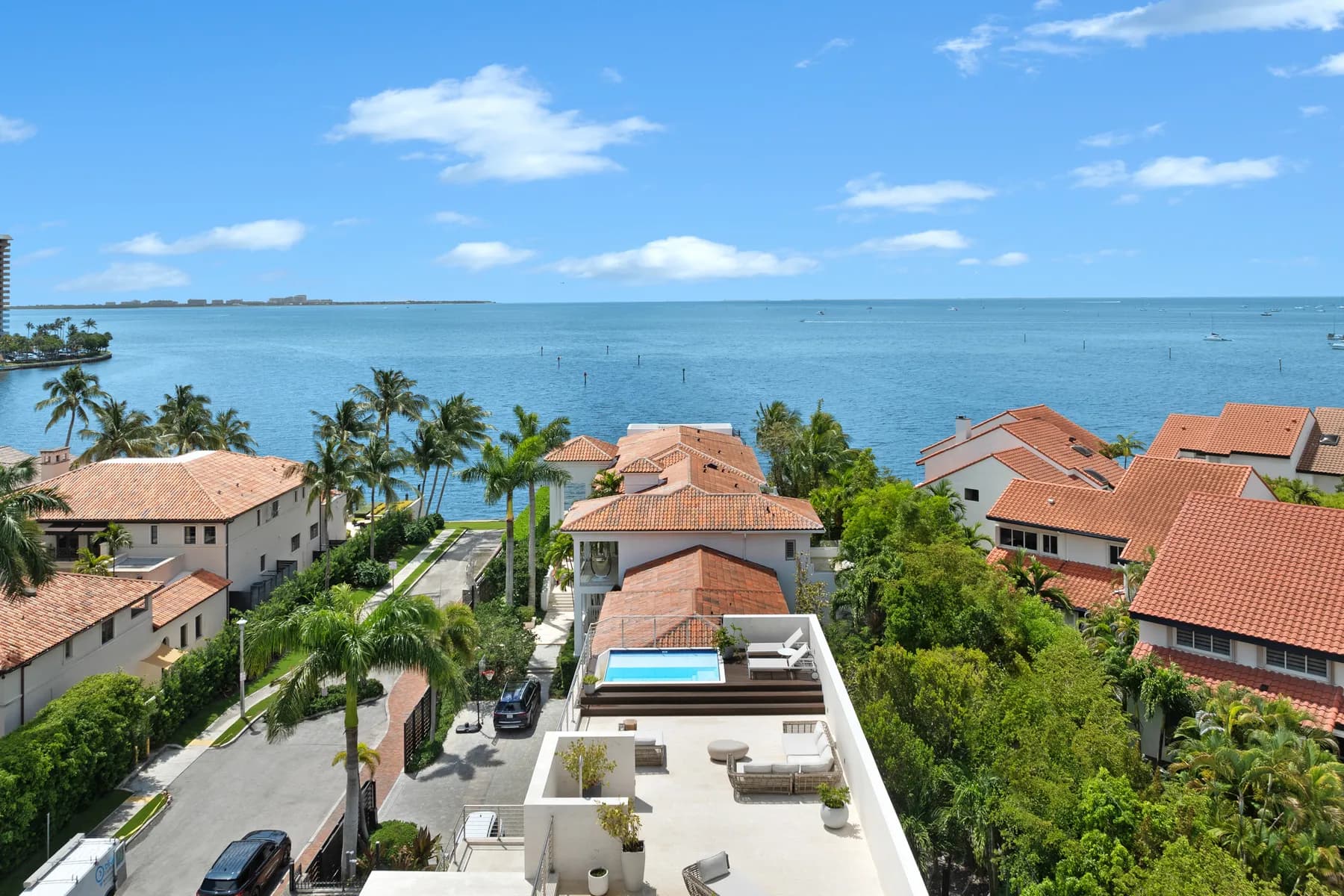 Aerial exterior view of the Crystal Residence on Biscayne Bay in Coconut Grove, with a rooftop pool and direct water access